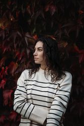 Fashion woman on a background of red and yellow autumn leaves