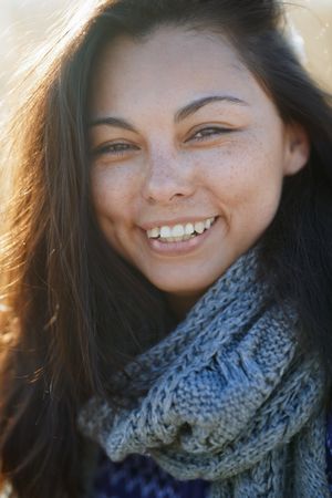 Happy woman outdoors looking at camera and laughing