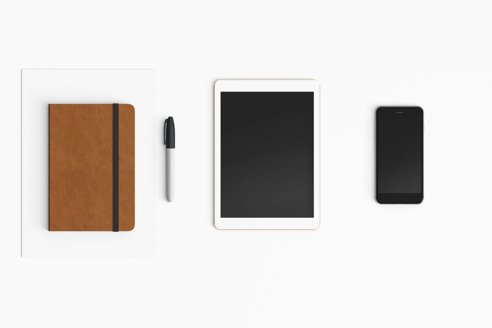 Modern workspace with coffee cup, smartphone, notebook and tablet copy space