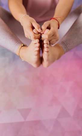 Faceless woman practicing yoga on pink mat