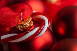 Christmas card concept with red bauble and candy cane