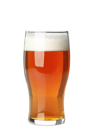 Glass of beer isolated on light background