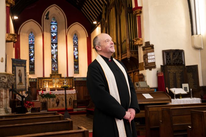 Vicar standing in parish