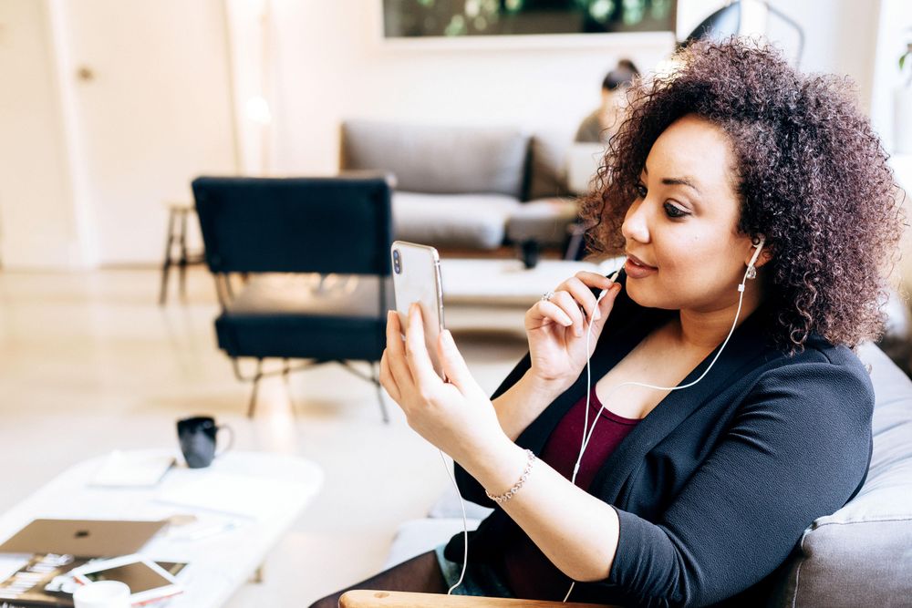 Woman having an online meeting on phone in an office