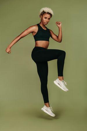 Black female athlete doing warm up exercises