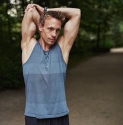 Man in sportswear stretching his arm