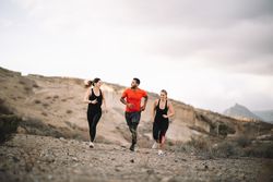 Multiracial friends jogging on nature together