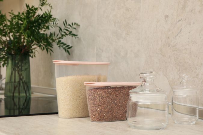 Modern kitchen interior with plastic containers with cereals