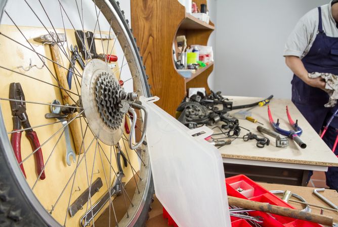 Wheel and bicycle parts over workshop table