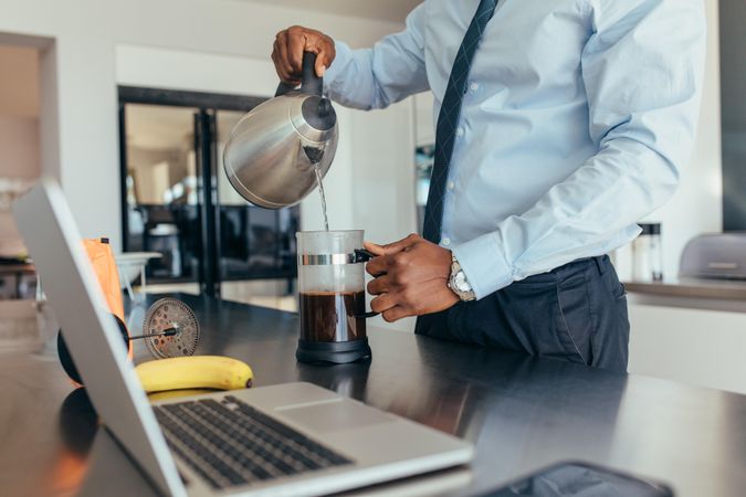 Man pouring hot water in coffee maker