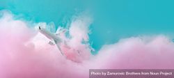 Cloud-like pink color paint with light  airplane on blue background 56MyN0