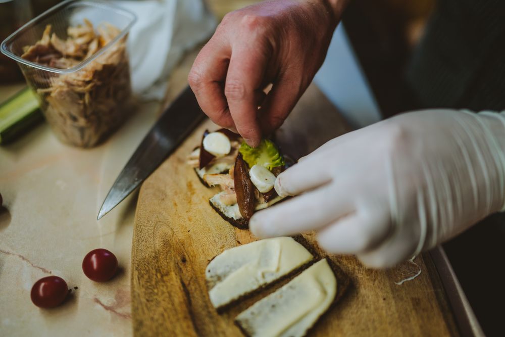 Cropped image of person preparing tapas