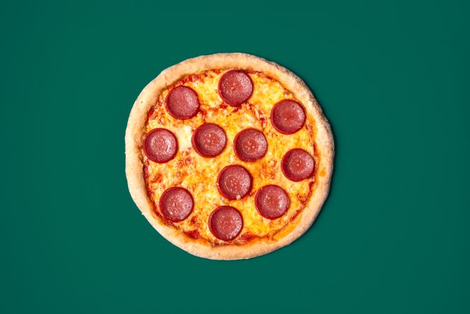 Pizza salami isolated on a green background