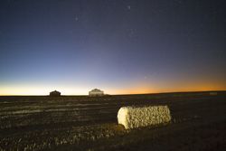 Rural fields in night with glowing sky