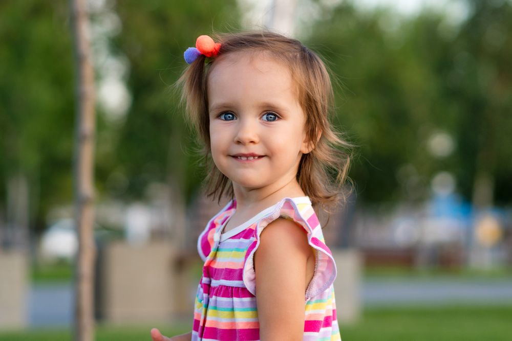 Toddler smiling outdoors
