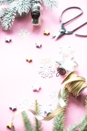 Christmas decorations of snowflakes and stars on pink background