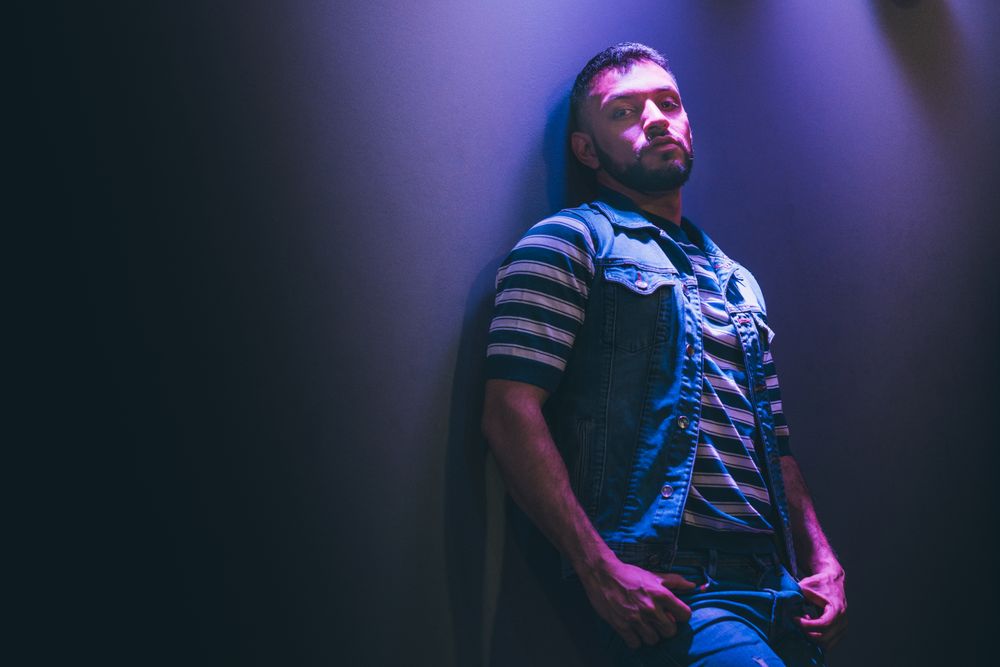bearded man dancing in spotlight