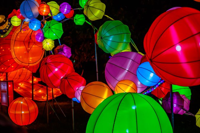 Colorful lit paper lanterns at night