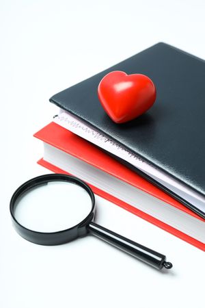 Medical literature - books and doctors accessories on light background