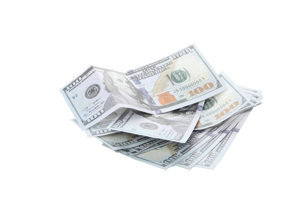 Stacks of American cash money, isolated on light background