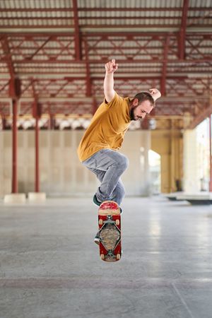 Young man doing an ollie with his skateboard