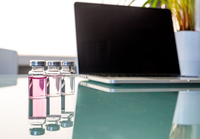 Open laptop and scientific samples on table