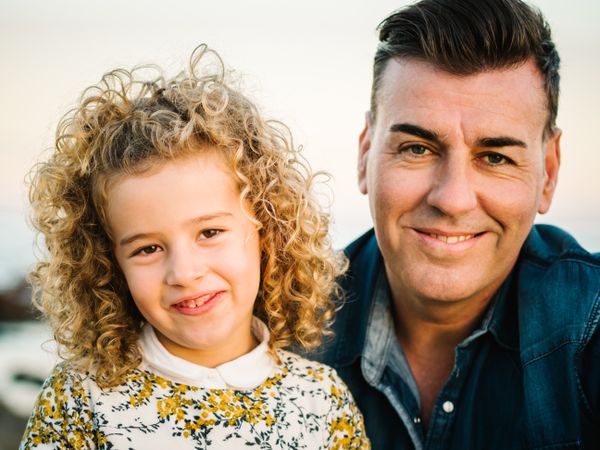Father with her daughter at beach