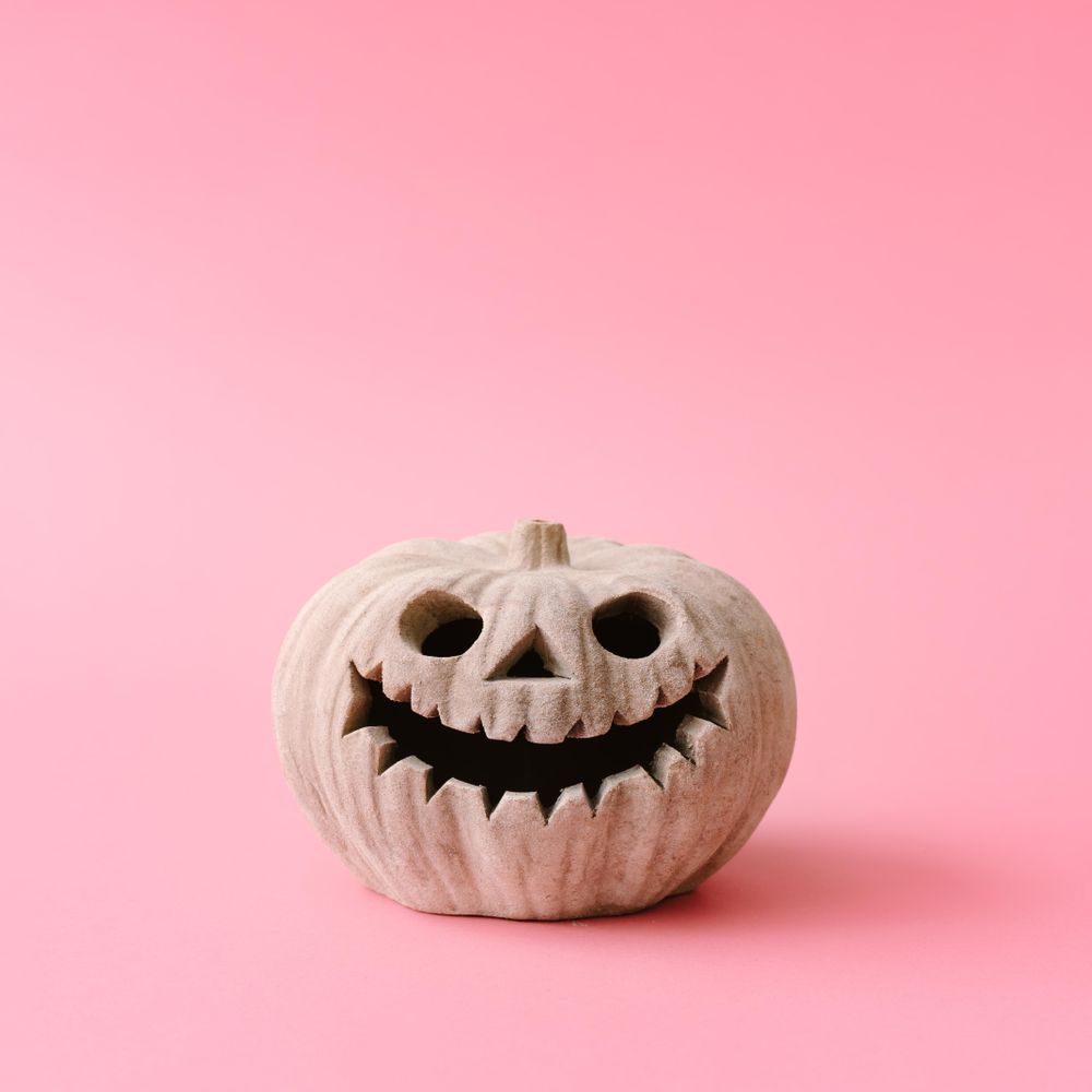 Pumpkin skull on pastel pink wall