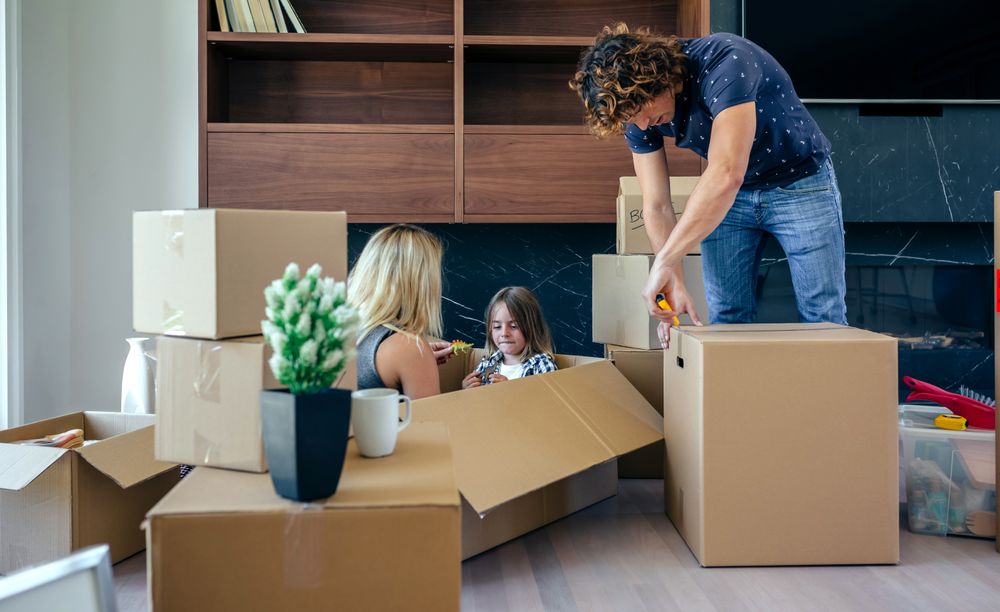Mother and son playing while father unpacks