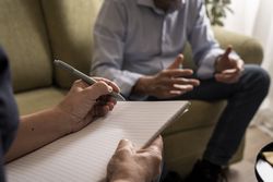 Man having an intense and dramatic therapy session with a psychologist.