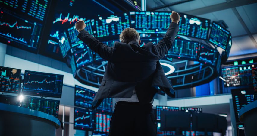 Professional Broker Excited About the Good News, Punches the Air in a Winning Fashion, Showing Positive Emotions. View From the Back