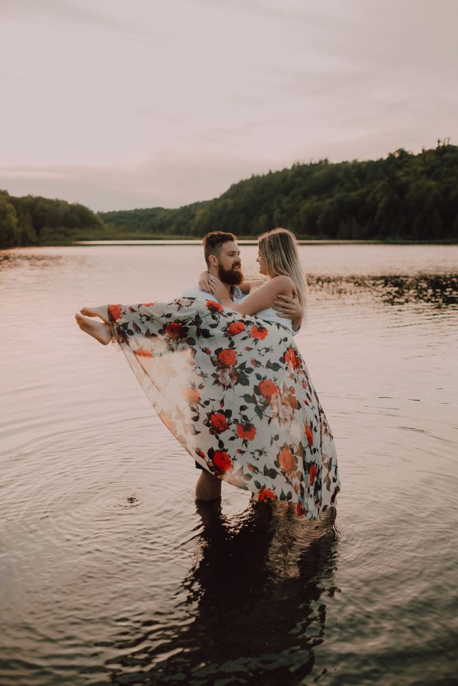 Loving couple standing ankle deep in water on beach