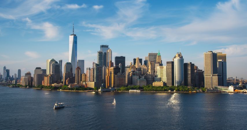 Panorama Around the Wall Street Financial District in New York City, USA. Aerial Shot with Office Buildings and Skyscrapers on a Summer Sunny Day with Blue Sky and Light Clouds