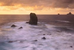 Amazing stone shore and pink sky with clouds