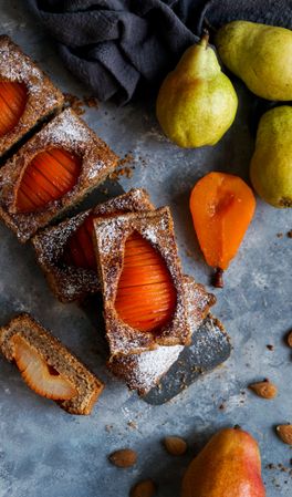 Pear cake and fruits on table
