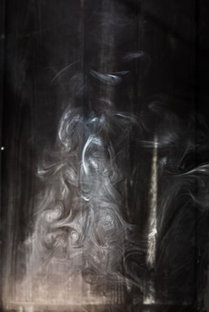 Swirls of smoke in a dark room