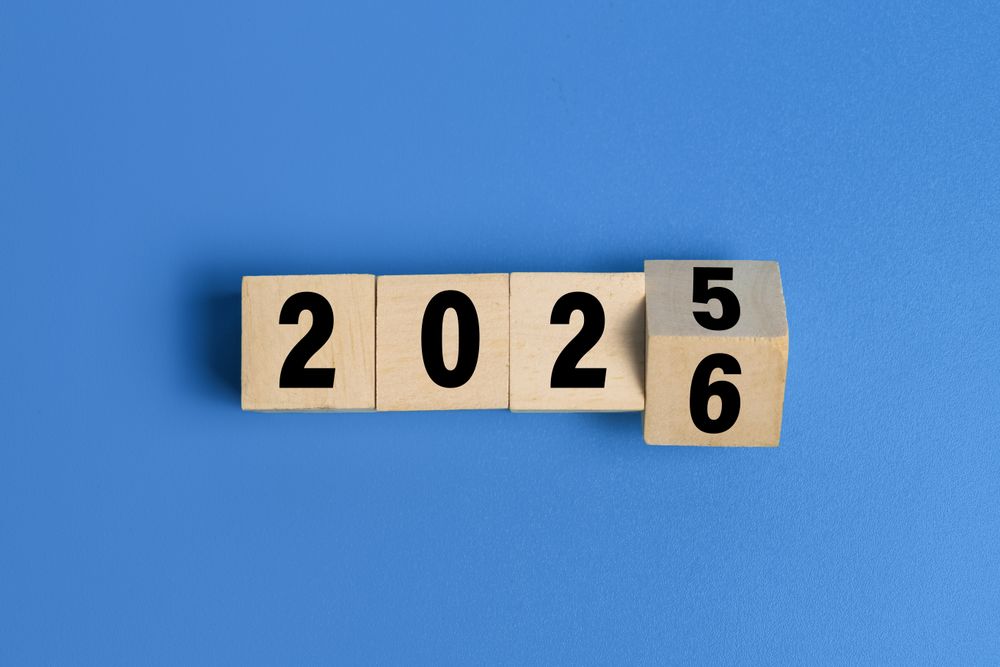 flip wooden blocks with year 2025 to 2026 isolated on blue background