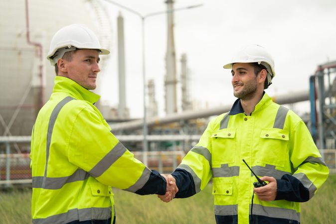 Engineer worker hand shaking to colleagues team for success work