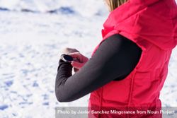 Cropped shot of woman in snow gear checking watch 5r9D91