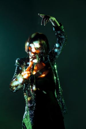 Stylish woman singing on stage