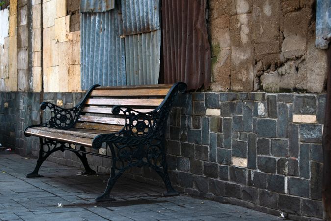 Vintage antique single brench on street side walk.