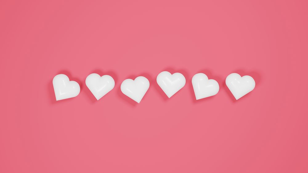 Plastic hearts on pink background