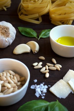 Ingredients for pesto pasta arranged at table