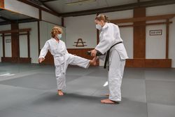 Woman teaching boy Krav Maga