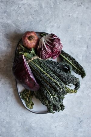 Pomegranate near red cabbage and kale