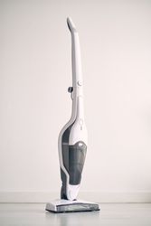 Contemporary vacuum cleaner placed on floor in apartment