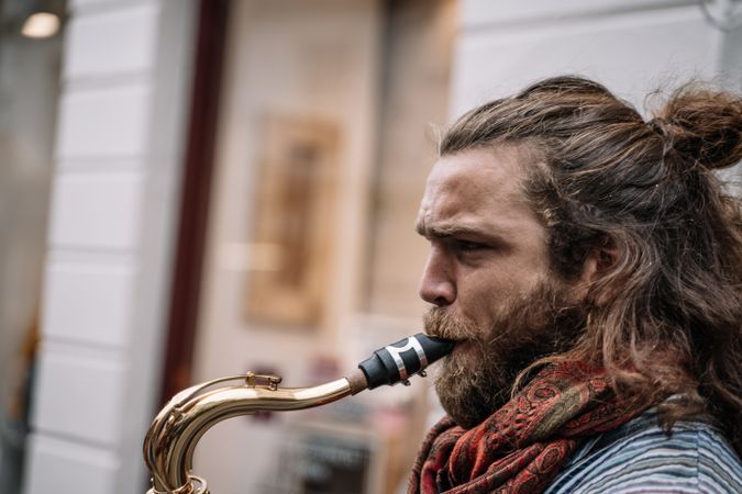 Male saxophonist plays Sax in the street