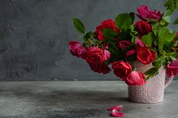 Side view of pink vase holding flowers