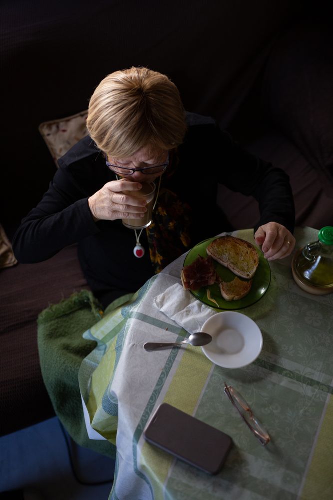 Older woman drinking coffee at breakfast