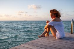 Young woman on pier near sea